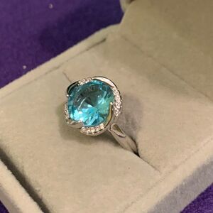 New, no tags. Blue sapphire in silver over stainless, adjustable, vivd colour